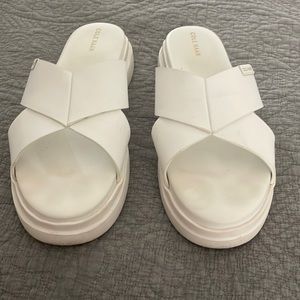 Cole Haan classic white leather platform crisscross slides.